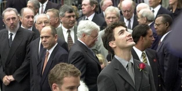 MONTREAL, CANADA - OCTOBER 3: The son of former Canadian Prime Minister Pierre Trudeau, Justin (R), looks up as he arrives in the company of his brother Sacha (lower center) at the state funeral for their father at the Notre Dame Basilica during Trudeau's state funeral 03 October 2000. Trudeau, who was considered to be one of Canada's most charismatic prime ministers, died of prostate cancer at age 80 at his home 28 September. Cuban President Fidel Castro can be seen at left. (Photo credit should read PHIL CARPENTER/AFP/Getty Images)