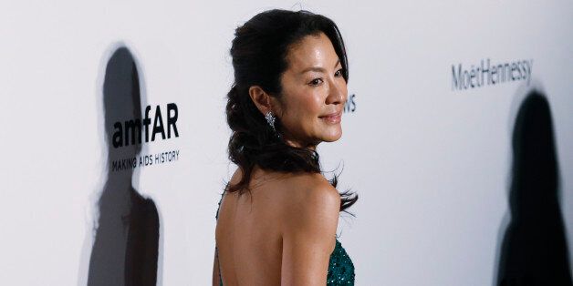 Malaysian actress Michelle Yeoh poses on the red carpet for the fundraising gala organized by amfAR (The Foundation for AIDS Research) in Hong Kong Saturday, March 14, 2015. (AP Photo/Kin Cheung)