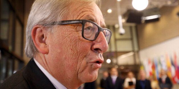 European Commission President Jean-Claude Juncker speak with the media as he arrives for an EU-Canada summit at the European Council building in Brussels, Sunday, Oct. 30, 2016. Canadian and EU officials, in a one-day summit, are to sign the Comprehensive Economic and Trade Agreement (CETA). (AP Photo/Olivier Matthys)