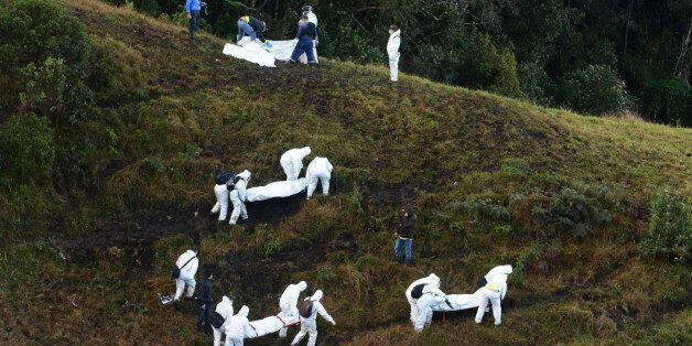 Rescue workers carry the bodies of victims of an airplane crash in a mountainous area near La Union, Colombia, Tuesday, Nov. 29, 2016. The plane was carrying the Brazilian first division soccer club Chapecoense team that was on its way for a Copa Sudamericana final match against Colombia's Atletico Nacional. (AP Photo/Luis Benavides)