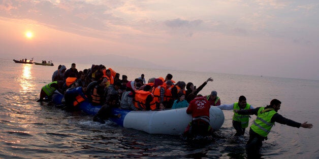 FILE - In this Sunday, March 20, 2016 file photo, volunteers help migrants and refugees on a dingy as they arrive at the shore of the northeastern Greek island of Lesbos, after crossing the Aegean sea from Turkey. Faced with a flood of more than 1 million migrants across the Mediterranean in 2015, European nations tightened border controls, set up naval patrols to stop smugglers, negotiated an agreement with Turkey to limit the numbers crossing, shut the Balkan route used by hundreds of thousands, and tried to speed up deportations of rejected asylum-seekers. (AP Photo/Petros Giannakouris, File)