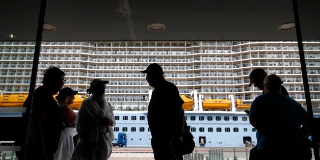 Tourists enter a passenger terminal, after their arrival with the