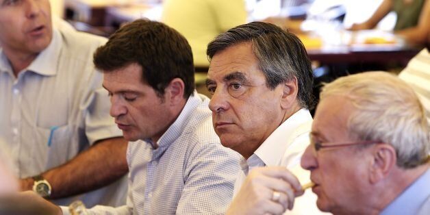 Former French Prime Minister and candidate for the right-wing Les Republicains (LR) party primary ahead of the 2017 presidential election Francois Fillon (C) looks on during the agricultural show of Chalons-en-Champagne on September 1, 2016.FranÃ§ois Fillon on September 1, 2016 wished 'good luck' and 'welcome to the club' to Emmanuel Macron, a potential rival for 2017, rejoicing that politicians outgoing of 'partisan debate' and developing 'innovative solutions' can 'talk together'. / AFP / FRANCOIS NASCIMBENI (Photo credit should read FRANCOIS NASCIMBENI/AFP/Getty Images)