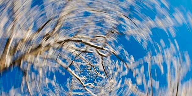 JAPAN - 2016/02/03: View of snow covered trees against a blue sky on Lake Abashiriko near Abashiri, a city on Hokkaido Island, Japan, using a slow shutter speed and rotating the camera to get a swirl. (Photo by Wolfgang Kaehler/LightRocket via Getty Images)