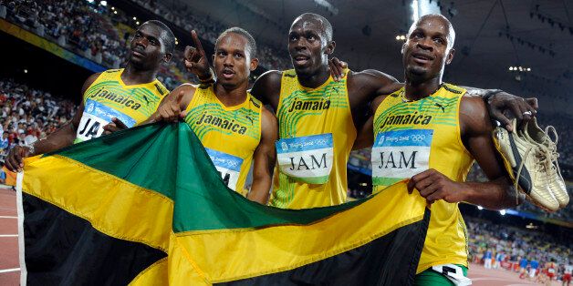 Men's 4x100m relay Asafa Powell, Usain Bolt, Michael Frater, Nesta Carter of Jamaica celebrate after winning the final of the athletics competition in the National Stadium during the Beijing 2008 Olympic Games August 22, 2008. REUTERS/Kai Pfaffenbach (CHINA)