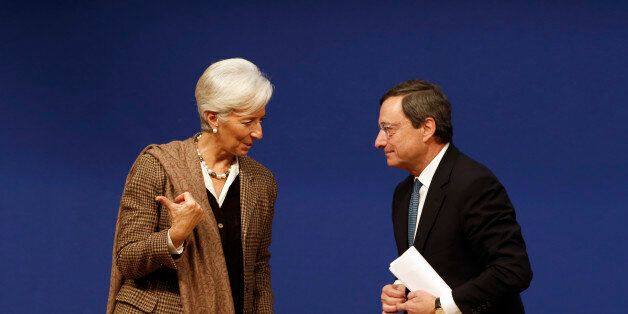 International Monetary Fund (IMF) Managing Director Christine Lagarde (L) and European Central Bank (ECB) President Mario Draghi leave after the conference