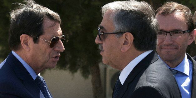 Cypriot President Nicos Anastasiades, left, breakaway Turkish Cypriot leader Mustafa Akinci, right, talks as the UN Special Advisor of the Secretary-General Espen Barth Eide, right, looks on as they leave their talks aimed at reunifying the ethnically divided island, at the disused Nicosia airport inside a United Nations controlled buffer zone on Wednesday, Sept. 14, 2016. The rival leaders of ethnically split Cyprus say they will meet with the U.N. Chief later this month to take stock of ongoin