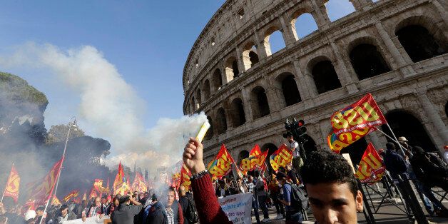 People march through downtown Rome to protest Matteo Renzi's government politics, Saturday, Oct. 22, 2016. In background is the Colosseum. ( AP Photo/Andrew Medichini)
