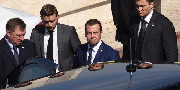 Russian Prime Minister Dmitry Medvedev (C) leaves on November 11, 2016 following his visit to the Yad Vashem Holocaust Memorial museum in Jerusalem commemorating the six million Jews killed by the Nazis during World War II. / AFP / POOL / DEBBIE HILL (Photo credit should read DEBBIE HILL/AFP/Getty Images)
