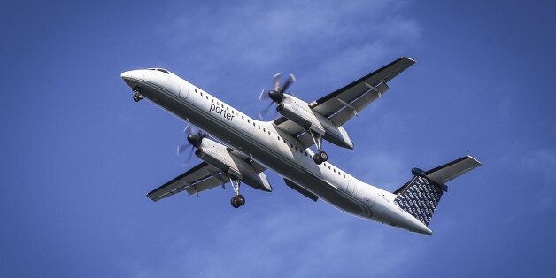TORONTO, ON- AUGUST 27 - A Porter airlines Q400 with it's wheels down on final approach passes over Cherry Beach en route to Billy Bishop Toronto City Airport. August 27, 2014. (David Cooper/Toronto Star via Getty Images)