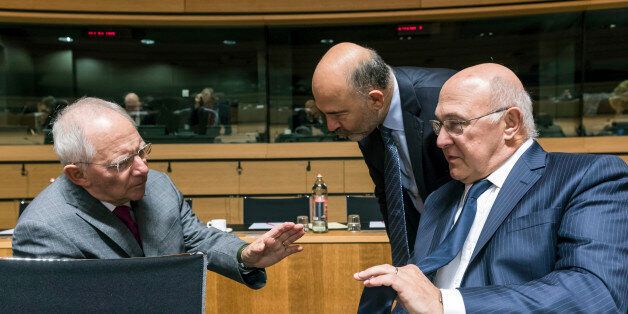 German Finance Minister Wolfgang Schauble, left, talks with Franch Finance Minister Michel Sapin, right, and European Commissioner for Economic Affairs, Taxation and Customs Pierre Moscovici during an EU finance ministers meeting at the EU Council in Luxembourg Tuesday, Oct. 11, 2016. (AP Photo/Geert Vanden Wijngaert)