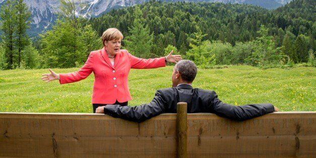 Germany's Chancellor Angela Merkel (L) gestures while chatting with US President Barack Obama sitting on a bench outside the Elmau Castle after a working session of a G7 summit near Garmisch-Partenkirchen, southern Germany, on June 8, 2015. AFP PHOTO / POOL / MICHAEL KAPPELER / AFP / POOL / MICHAEL KAPPELER (Photo credit should read MICHAEL KAPPELER/AFP/Getty Images)