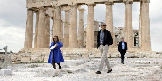 US President Barack Obama (R) walks in front of the Parthenon during a tour of the Acropolis on November 16, 2016 in Athens, Greece.Obama will sketch out his vision of democracy at a time of mounting global populism, seeking to soothe European allies anxious over a Donald Trump presidency. / AFP / Brendan Smialowski (Photo credit should read BRENDAN SMIALOWSKI/AFP/Getty Images)