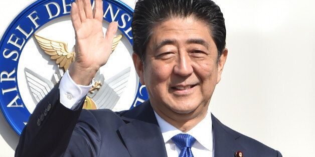 Japan's Prime Minister Shinzo Abe waves to well-wishers prior to boarding a government plane at Tokyo's Haneda on November 17, 2016. Abe headed to New York on November 17 for talks with Donald Trump, the first leader to meet with the president-elect whose campaign pledges provoked anxiety over US foreign policy./ AFP / KAZUHIRO NOGI (Photo credit should read KAZUHIRO NOGI/AFP/Getty Images)