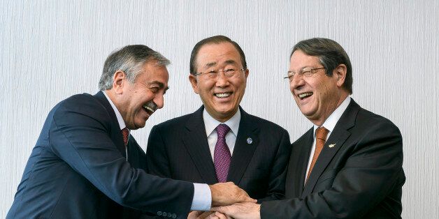 U.N. Secretary-General Ban Ki-moon (C) pose for photographers with Turkish Cypriot leader Mustafa Akinci (L) and Cypriot President Nicos Anastasiades during the Cyprus reunification talks in the Swiss mountain resort of Mont Pelerin, Switzerland November 7, 2016. REUTERS/Fabrice Coffrini/Pool