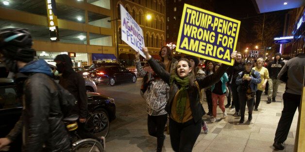 Demonstrators march following a protest against President-elect Donald Trump in downtown Indianapolis on Saturday, Nov. 12, 2016. Tens of thousands of people marched in streets across the United States on Saturday, staging the fourth day of protests of Trump's surprise victory as president. (AP Photo/AJ Mast)