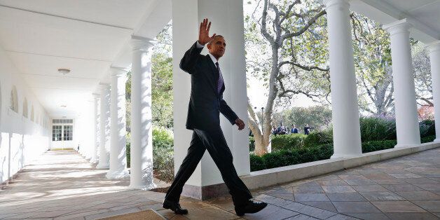 President Barack Obama waves as he walks down the White House Colonnade from the main residence to the...