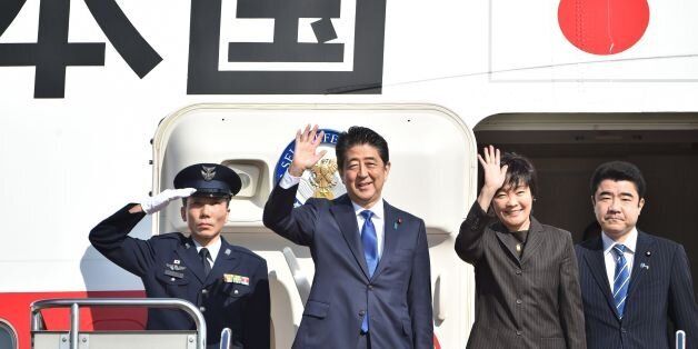 Japan's Prime Minister Shinzo Abe (2nd L) and his wife Akie (2nd R) wave to well-wishers prior to boarding a government plane at Tokyo's Haneda on November 17, 2016.Abe headed to New York on November 17 for talks with Donald Trump, the first leader to meet with the president-elect whose campaign pledges provoked anxiety over US foreign policy. / AFP / KAZUHIRO NOGI (Photo credit should read KAZUHIRO NOGI/AFP/Getty Images)
