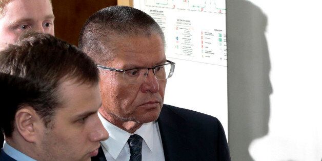 Russian Economic Development minister Alexei Ulyukayev, right, is escorted to a court room in Moscow, Russia, Tuesday, Nov. 15, 2016. Ulyukayev was detained late Monday after he allegedly received a $2 million bribe in a sting set by the FSB, the KGB's main successor agency, the Investigative Committee said in a statement on Tuesday. (AP Photo/Ivan Sekretarev)