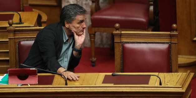 Greek Finance Minister Euclid Tsakalotos attends a Parliament meeting in Athens, Tuesday, Sept. 27, 2016. Greek labor unions are organizing strikes and protests against a plan to place major state assets under the control of a new privatization fund that will be headed by bailout creditors. The fund called the Hellenic Company of Assets and Participations will take control of public utilities and other assets for 99 years if parliament approves draft legislation late Tuesday. (AP Photo/Petros Gi