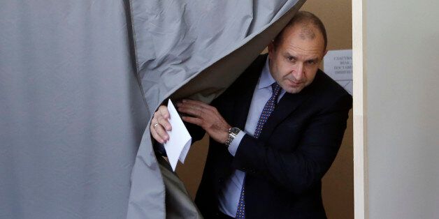 Bulgarian Socialists Party candidate Rumen Radev comes out from the polling booth at a polling station in Sofia, Bulgaria, Sunday, Nov. 13, 2016. Bulgarians went to the polls on Sunday to choose their new president in a hotly contested runoff that may also determine the fate of the country's center-right government. (AP Photo/Darko Vojinovic)