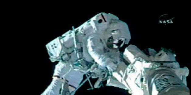 Astronaut Shane Kimbrough, attached to a work platform on the end of the Space Shuttle Endeavour's robotic arm, lubricates the Latching End Effector snare at the end of the space station's robot arm during his spacewalk in this view from NASA TV November 20, 2008. REUTERS/NASA TV (UNITED STATES). FOR EDITORIAL USE ONLY. NOT FOR SALE FOR MARKETING OR ADVERTISING CAMPAIGNS.