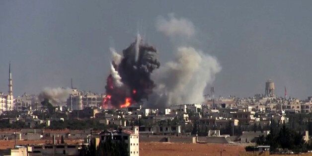 This frame grab from video provided by this militant video by Fatah al-Sham Front that is consistent with independent AP reporting, shows flames and smoke rise from a suicide bomb attacked Syrian government forces positions, in western Aleppo, Syria, Thursday, Nov. 3, 2016. The Britain-based Syrian Observatory for Human Rights, which monitors the conflict through local contacts, reported that rebels attacked government positions with two explosives-laden vehicles. Syrian rebels launched a fresh wave of attacks on western districts of Aleppo Thursday as airstrikes on a rebel-held village south of the contested city killed civilians, activists said. (militant video by Fatah al-Sham Front, via AP)