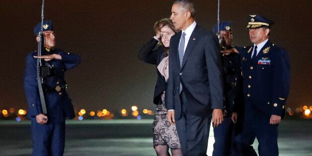 President Barack Obama walks across the tarmac with Second Vice President of Peru Mercedes Araoz, center, during his arrival at Jorge Chavez International Airport in Lima, Peru, Friday, Nov. 18, 2016. Obama traveled to South America to attend the annual Asia-Pacific Economic Cooperation (APEC) forum. (AP Photo/Pablo Martinez Monsivais)