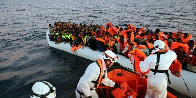 Migrants on a dinghy boat are being rescued by the vessel Responder, run by the Malta-based NGO Migrant Offshore Aid Station (MOAS) and the Italian Red Cross, in the Mediterranean sea, early Saturday, Nov. 5, 2016. (Francesco Malavolta/MOAS via AP)