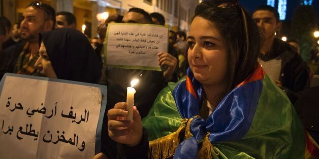 Moroccans protesters carry candles during a demonstration on November 6, 2016 in the capital Rabat, to demand justice for a fish seller whose gruesome death, when he was crushed in a rubbish truck, sparked nationwide outrage.Mouhcine Fikri, 31, was accidentally killed last on October 29, in the northern city of Al-Hoceima as he tried to protest against the seizure and destruction of swordfish, which are not allowed to be caught at this time of year. / AFP / FADEL SENNA (Photo credit shoul