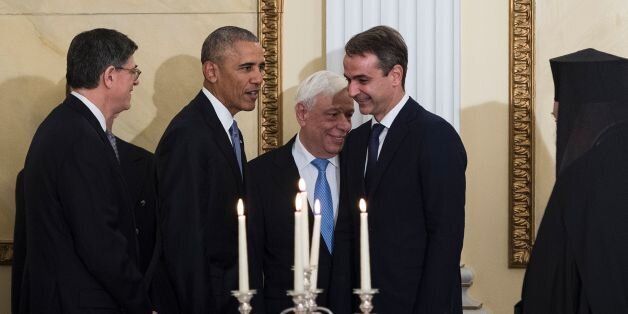 US President Barack Obama (2nd L) arrives for a state dinner flanked by Greek President Prokopis Pavlopoulos...