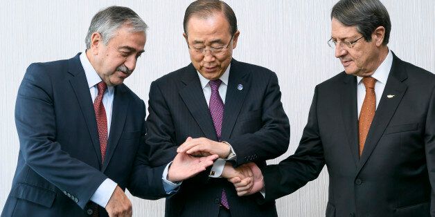 United Nations Secretary General Ban Ki-moon, center, poses with Turkish Cypriot leader Mustafa Akinci, left, and Greek Cypriot President Nicos Anastasiades at the beginning of Cyprus Peace Talks, Monday, Nov. 7, 2016, in Mont Pelerin, Switzerland. Ban is urging the rival leaders of ethnically divided Cyprus to seize the opportunity for a reunification deal that he says is within their reach. (Fabrice Coffrini/Pool Photo via AP)