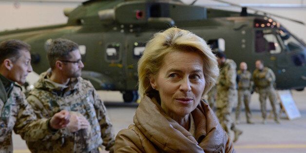 FILE - In this Dec. 13, 2014 file picture German Defense Minister Ursula von der Leyen, center, greets German helicopter pilots in a hangar at Camp Marmal in Mazar-i-Sharif, Afghanistan. Germany is affirming its growing role on the world stage in new security guidelines that mark another step away from its caution after World War II. A draft defense policy paper obtained by The Associated Press Tuesday July 12, 2016 and due to be presented on Wednesday states that