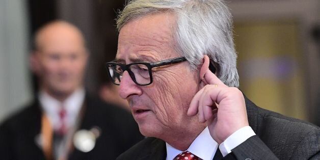 European Commission President Jean-Claude Juncker gestures while listening to journalists' questions as he leaves at the end of an European Union leaders summit on October 21, 2016 at the European Council, in Brussels. / AFP / EMMANUEL DUNAND (Photo credit should read EMMANUEL DUNAND/AFP/Getty Images)
