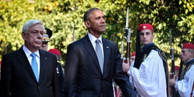 US President Barack Obama and his Greek couterpart Prokopis Pavlopoulos (L) review a presidential honour guard durig the official welcoming ceremony at the presidental palace in Athens on November 15, 2016.Obama flew into Athens on his final foreign trip to Europe, seeking to calm the nerves of allies concerned by Donald Trump's shock presidential election victory. / AFP / LOUISA GOULIAMAKI (Photo credit should read LOUISA GOULIAMAKI/AFP/Getty Images)