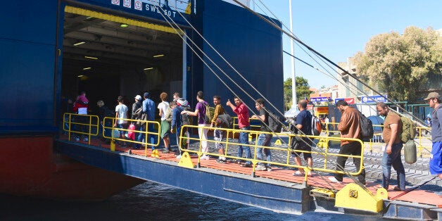 Editorial - LESVOS, GREECE - SEPTEMBER 30, 2015: Refugee migrants queue as they board a ferry from Mytilene, Lesvos to Kavala, Northern Greece before they head for Macedonia as they continue their journey through Europe.