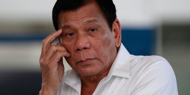 Philippine President Rodrigo Duterte listens to a question from reporters at Manila's International Airport, Philippines on Wednesday, Nov. 9, 2016. Duterte is set to fly to Bangkok to pay his respects to late Thailand's King Bhumibol Adulyadej. He then goes to Malaysia for an official visit. (AP Photo/Aaron Favila)