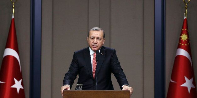 Turkey's President Recep Tayyip Erdogan speaks to the media at Esenboga Airport before a visit to Pakistan, in Ankara, Turkey, Wednesday, Nov. 16, 2016. Erdogan has criticized protests in the United States against Donald Trump, saying the president-elect should be respected and given time to show how he will govern. (Kayhan Ozer, Presidential Press Service, Pool photo via AP)