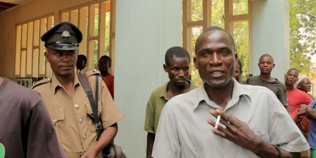 Eric Aniva (R), known as a 'hyena,' arrives to the Magistrate Court on August 15, 2016 in Nsanje.The trial of Eric Aniva, known as a 'hyena,' resumed on August 15. A Malawi court August 5 denied bail to the HIV-positive man who is facing charges of having sex with more than 100 adolescent girls as part of initiation rites into womanhood. Aniva was arrested last month, after he revealed that families paid him between four and seven dollars to have sexual intercourse with their children, in a traditional custom meant to prepare them to become good wives. / AFP / ELDSON CHAGARA (Photo credit should read ELDSON CHAGARA/AFP/Getty Images)