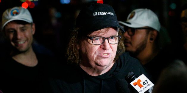US filmmaker Michael Moore speaks with members of the media as he arrives at the IFC Theater before the debut of a surprise documentary about Republican presidential nominee Donald Trump titled 'TrumpLand' in New York on October 18, 2016. / AFP / KENA BETANCUR (Photo credit should read KENA BETANCUR/AFP/Getty Images)