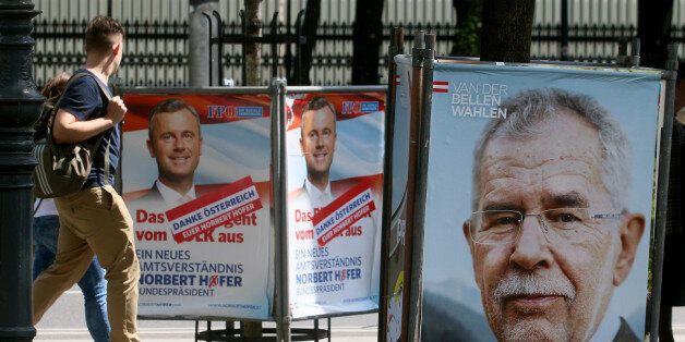 People walk between election posters of Alexander Van der Bellen, candidate for presidential elections and former head of the Austrian Greens, right, and Norbert Hofer, candidate for presidential elections of Austria's right-wing Freedom Party, FPOE, left, in Vienna, Austria, Monday, May 23, 2016. The Eurosceptic, anti-immigration right-winger Norbert Hofer, and his left-leaning rival are neck and neck in Austria's presidential election a day after polls closed, and officials are now counting