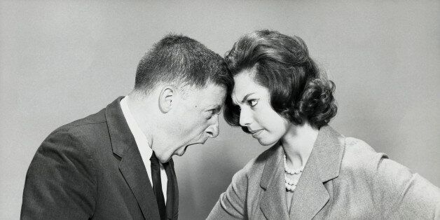 Side profile of a young couple shouting at each other