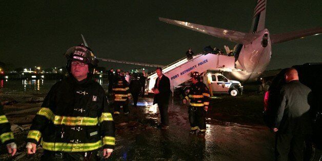 The campaign plane of Republican vice presidential candidate Indiana Gov. Mike Pence sits off a runway at New York's LaGuardia Airport Thursday, Oct. 27, 2016, after it slid off a runway during a rainstorm during landing. Pence told reporters that no one had been injured. (Ines DeLaCuetara/ABC News via AP)