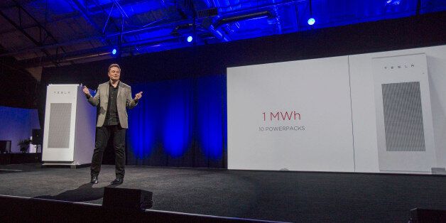 FILE - In this April 30, 2015 file photo, Tesla Motors Inc. CEO Elon Musk unveils the companyâs newest product, Powerpack in Hawthorne, Calif. Musk is trying to steer his electric car company's battery technology into homes and businesses as part of an elaborate plan to reshape the power grid with millions of small power plants made of solar panels on roofs and batteries in garages. One of the key technologies that could help wean the globe off fossil fuel is probably at your fingertips or