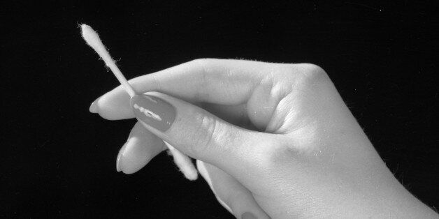 2nd May 1961: A manicured female hand holding a cotton bud, designed for cleaning the ear. (Photo by Chaloner Woods/Getty Images)