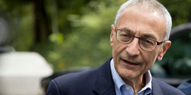 In this photo taken Oct. 5, 2016 file photo, Hillary Clinton's campaign manager John Podesta speaks to members of the media outside Democratic presidential candidate Hillary Clinton's home in Washington. Hacked emails reveal internal disagreement among top Clinton aides about her determination to hold a Clinton Foundation summit in Morocco that later drew attention over its reliance on large donations from foreign governments. (AP Photo/Andrew Harnik, File)