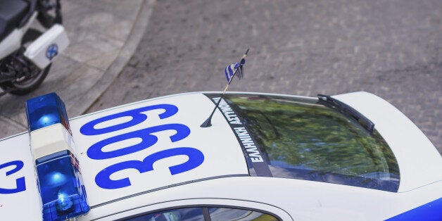 Elevated view of Greek policeman and car