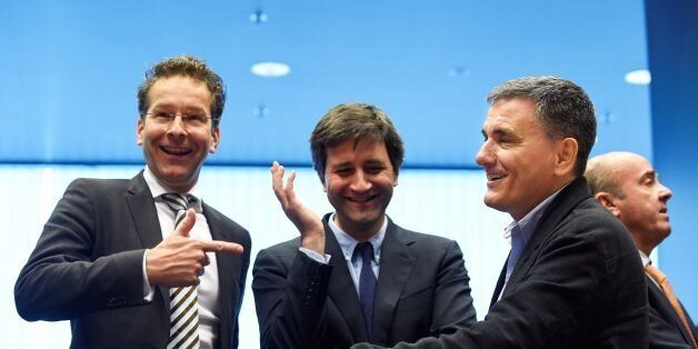Dutch Finance Minister and president of Eurogroup Jeroen Dijsselbloem (L) talks with Greek Finance Minister Euclid Tsakalotos (R) next to a Greek advisor during an Eurogroup meeting in Luxembourg on October 10, 2016.Greece has delivered the reforms necessary to unlock 2.8 billion euros in rescue loans from its massive third bailout, the European Commission's top economics affairs official said on October 10, 2016. / AFP / JOHN THYS (Photo credit should read JOHN THYS/AFP/Getty Images)