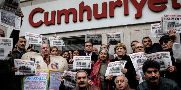 Protesters hold copies of the latest edition of the Turkish daily newspaper 'Cumhuriyet' during a demonstration in support to the Cumhuriyet in front of its headquarters in Istanbul on November 1, 2016. Turkish police on October 31, 2016, detained the editor-in-chief of the newspaper Cumhuriyet -- a thorn in the side of President Recep Tayyip Erdogan -- as Ankara widens a crackdown on opposition media. The Cumhuriyet, which had published revelations embarrassing for the government, said at least