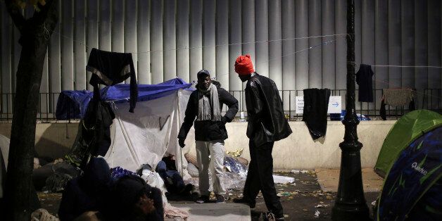 Migrants gather in a makeshift camp in Paris, Friday, Nov. 4, 2016. Police and city officials are clearing out hundreds of migrants camped out on sidewalks in northern Paris in a camp that recently grew into a new challenge for the French government. (AP Photo/Thibault Camus)